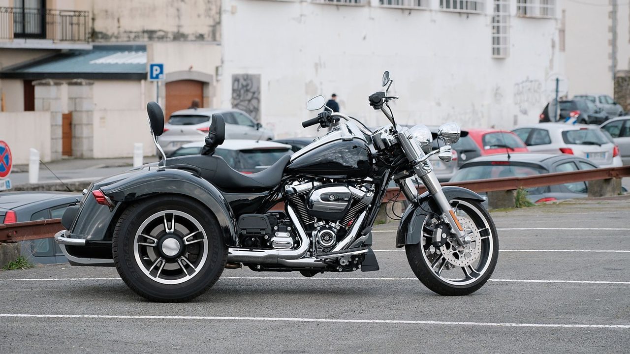 Moto aparcada en la calle con candado de disco amarillo y cadena